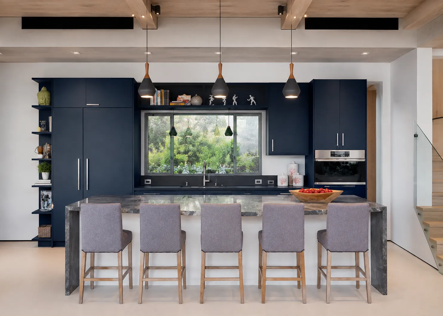 GEORGE navy kitchen design with blue perimeter cabinets and island under daylight and pendant lighting.