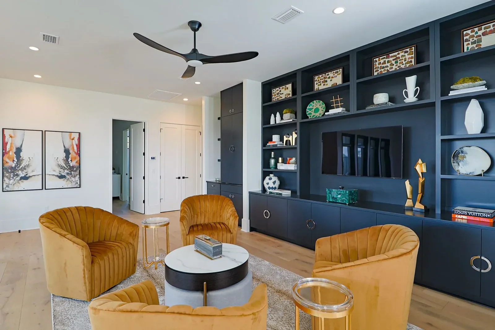 Florida villa project living room with dark media and display cabinetry