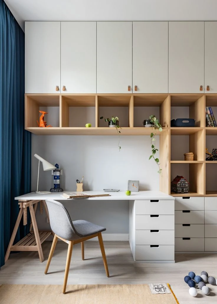 GEORGE light-toned home-office design with a long work surface, overhead cabinets, open shelves and drawer storage