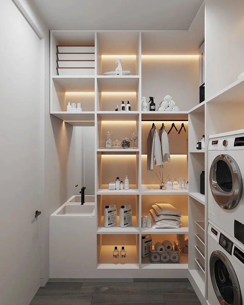 Tall laundry storage fitted beside stacked laundry appliances