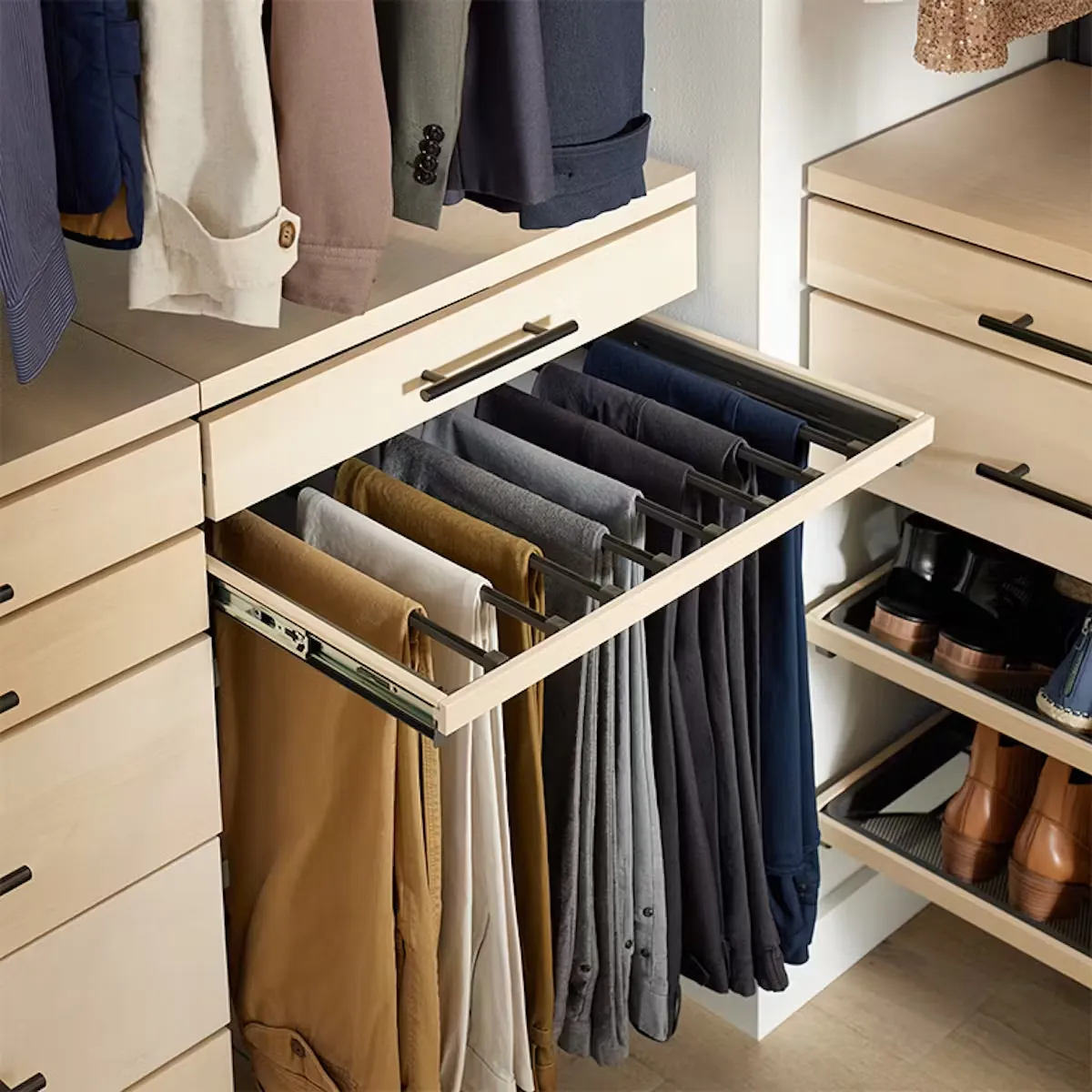 GEORGE pull-out trouser rack extended from a wardrobe beside hanging clothes and shelves.