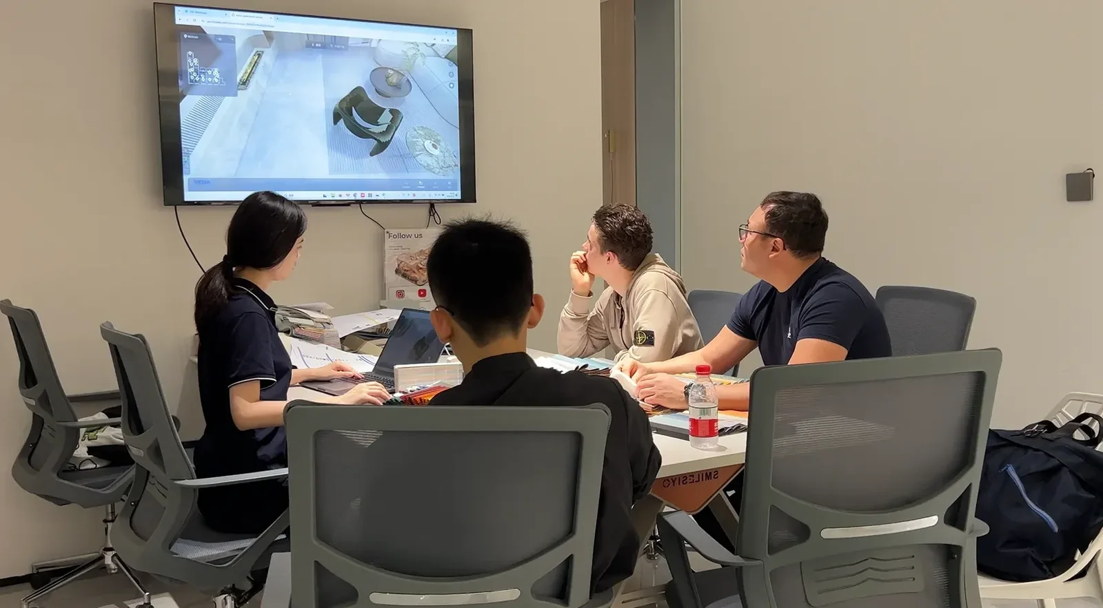 People reviewing material samples in a meeting room