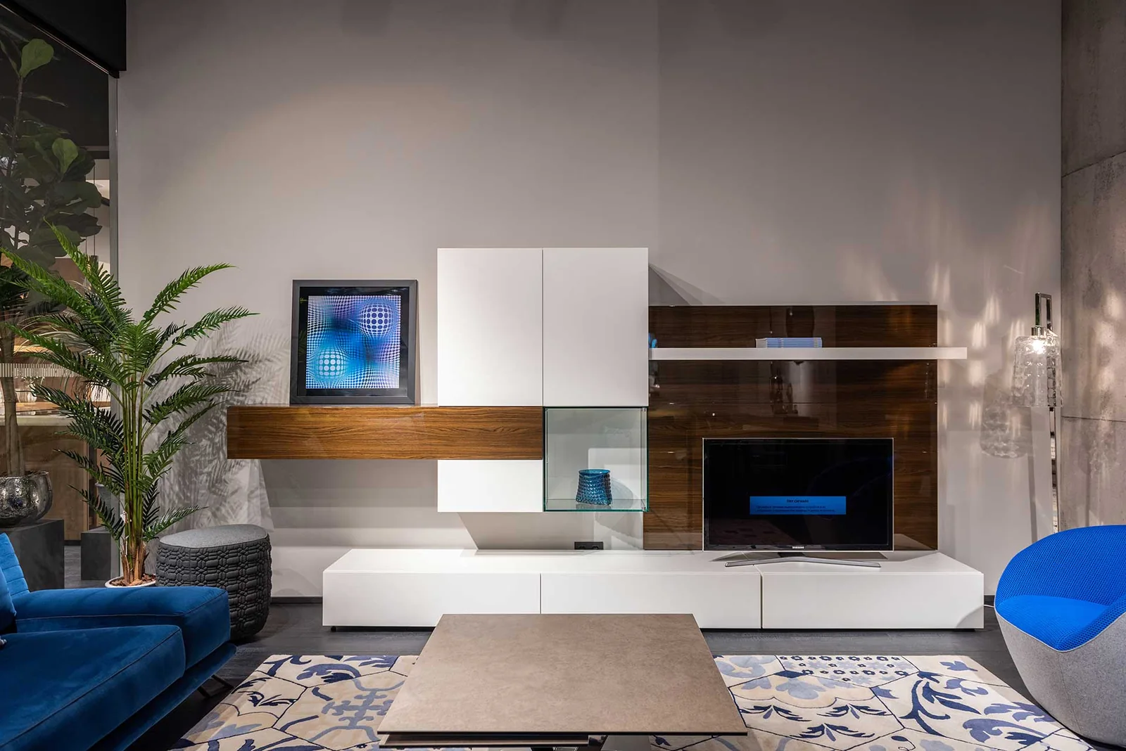 Living room cabinetry integrating a television, drawers and display areas