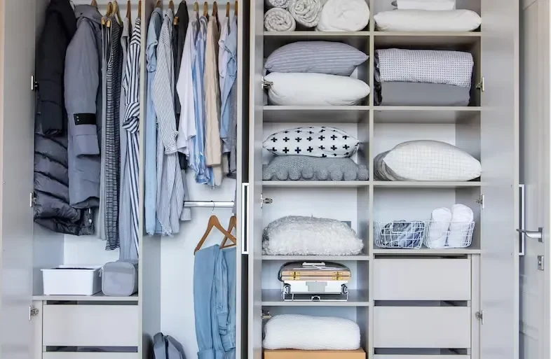 Open GEORGE Group wardrobe example with hanging rails, shelves and drawers arranged at different heights