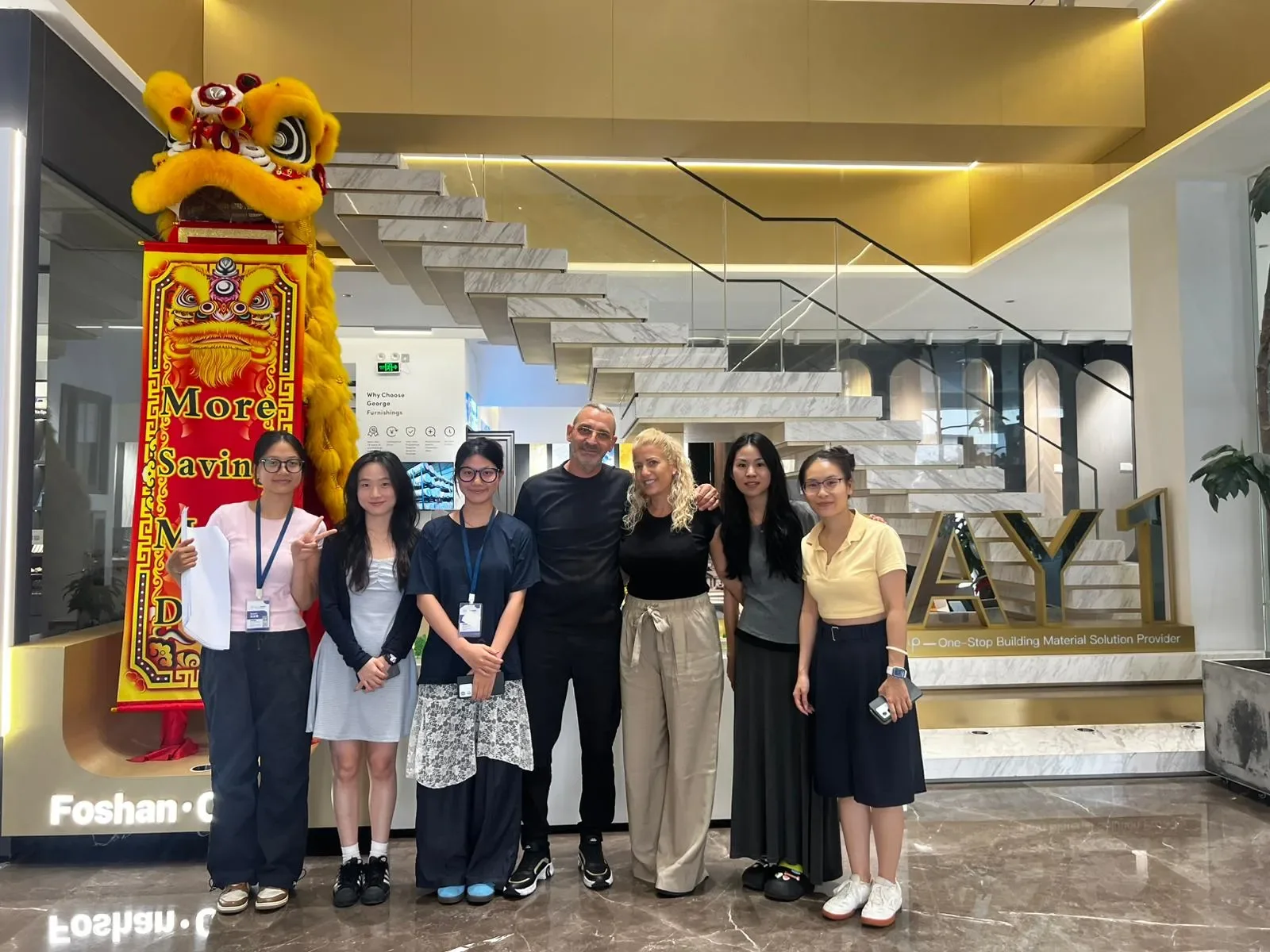 Group photograph at a GEORGE showroom entrance