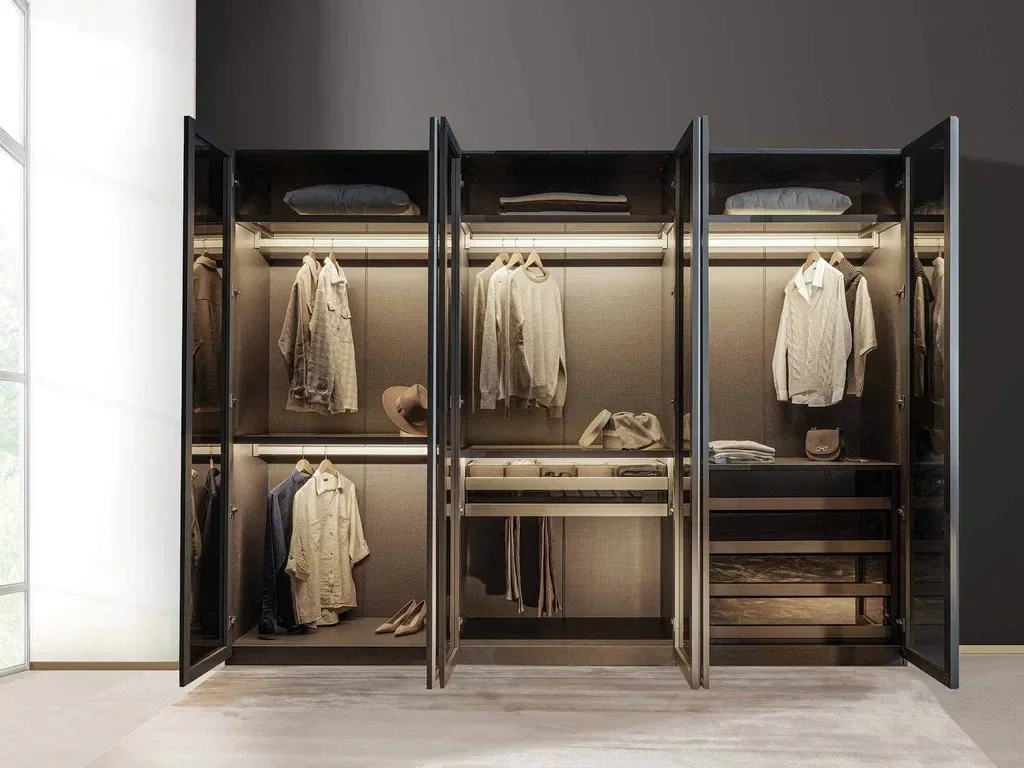 Dark wardrobe with glass hinged doors and illuminated hanging sections