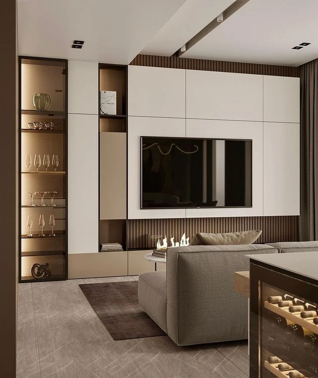 GEORGE living-room design with a television recessed into a full-height cabinet wall, display shelves and base storage.